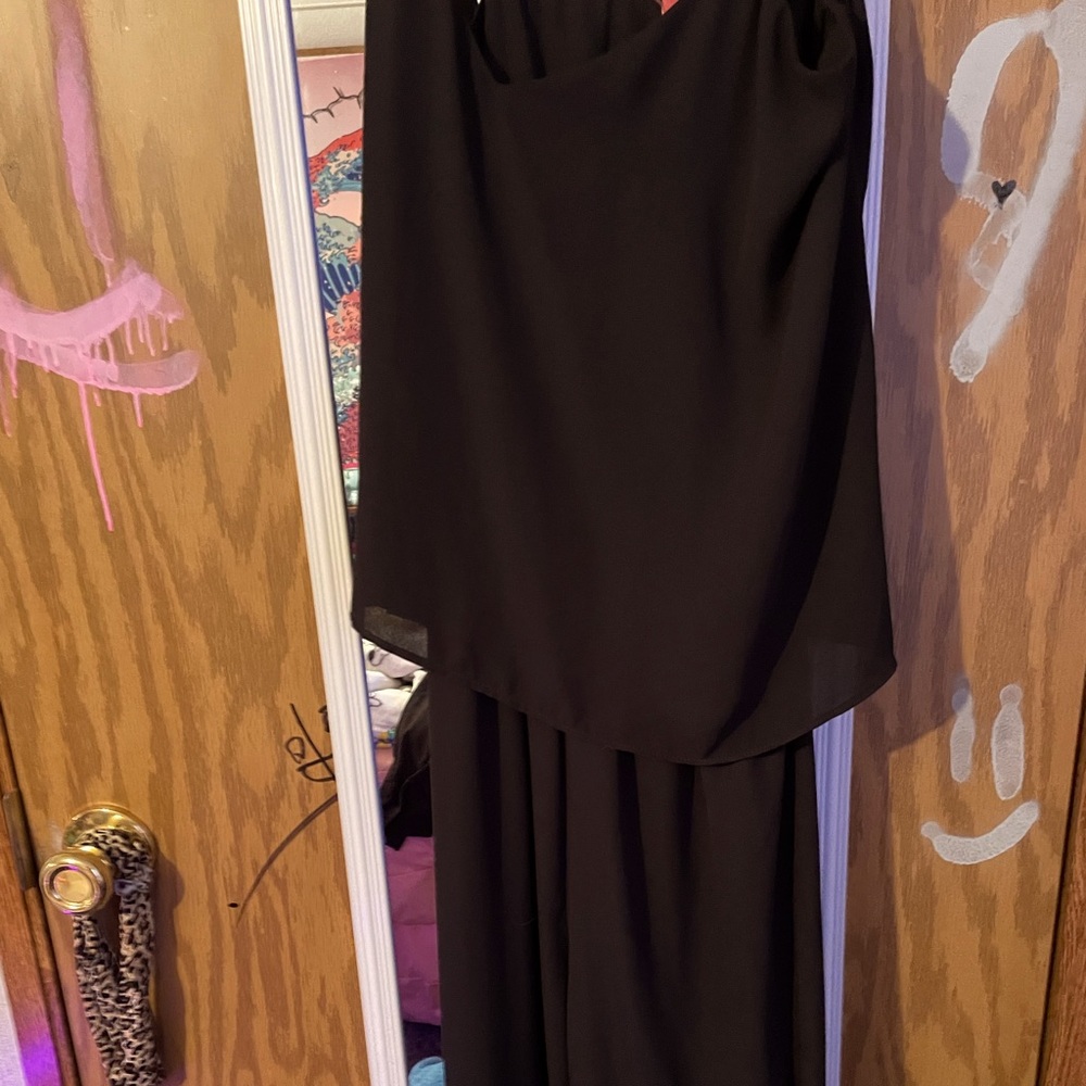 A long black jumper with ruffly top